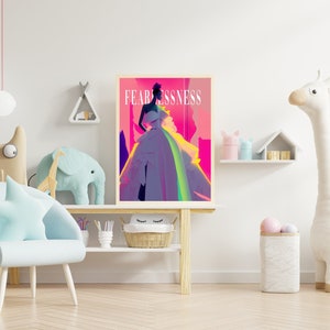 May include: A colorful illustration of a woman in a dress with the word "Fearlessness" printed above her. The illustration is framed and hanging on a white wall in a child's room.