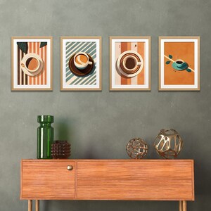 May include: Four framed prints of coffee cups with different backgrounds. The prints are hung on a gray wall above a wooden table with two decorative metal orbs.