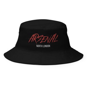 May include: Black bucket hat with a red "ARSENAL" logo and white "NORTH LONDON" text.