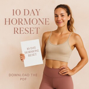 May include: A woman in a beige sports bra and mauve leggings holds a white card with the text "10 DAY HORMONE RESET." The background features the text "10 DAY HORMONE RESET" and "DOWNLOAD THE PDF" in a similar color.