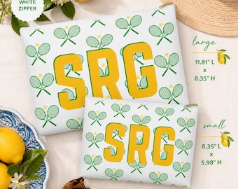 May include: Two white zippered pouches with a tennis theme. The pouches have a pattern of green tennis rackets and yellow tennis balls. Large pouch is 11.81" L x 8.35" H. The smaller pouch is 8.35" L x 5.98" H. Both pouches have the letters "SRG" in yellow.