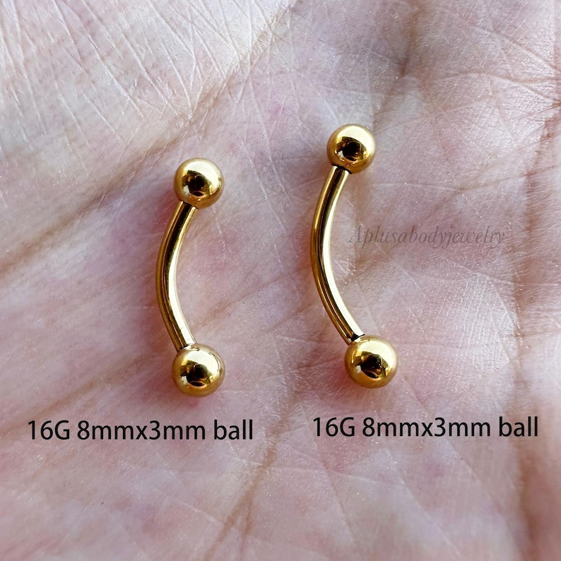 May include: Two gold 16G curved barbell body jewelry pieces with 8mm length and 3mm ball ends.