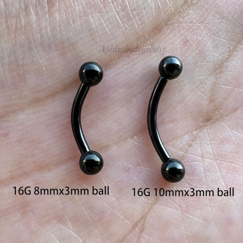 May include: Two black curved barbell piercings with 3mm balls. The left barbell is 8mm long and the right barbell is 10mm long. Both are 16 gauge.