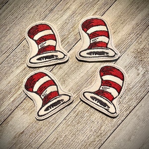 May include: Four felt patches shaped like the Cat in the Hat's hat, with red and white stripes.