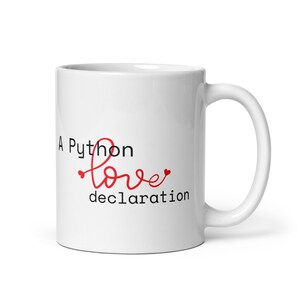 May include: White ceramic mug with a black and red design that says "A Python love declaration".