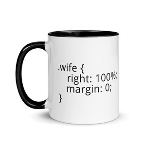 May include: White ceramic mug with a black rim and handle. The mug has black text that reads '.wife { right: 100%; margin: 0; }'.