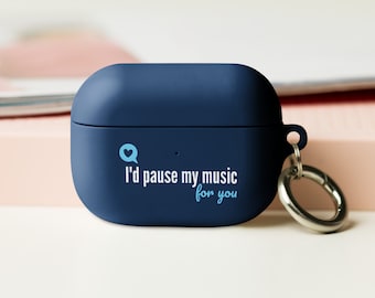 May include: A dark blue Airpods case with a white speech bubble and the text "I'd pause my music for you". The case has a silver keychain attached.