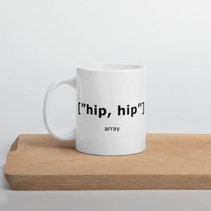 May include: White ceramic mug with black text that reads "['hip, hip']" and the word "array" underneath.