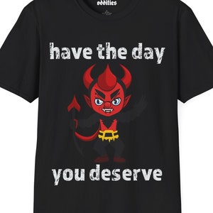May include: Black t-shirt featuring a red cartoon devil and the text "have the day you deserve".