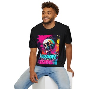 May include: Black t-shirt featuring a colorful skull design with the words "TOO DOPE TO DIE". The graphic includes vibrant pink, blue, yellow, and orange paint splatters, creating a bold and eye-catching aesthetic.