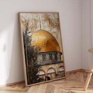 May include: A framed painting of a golden dome building with a brown and green background. The painting is leaning against a white wall.