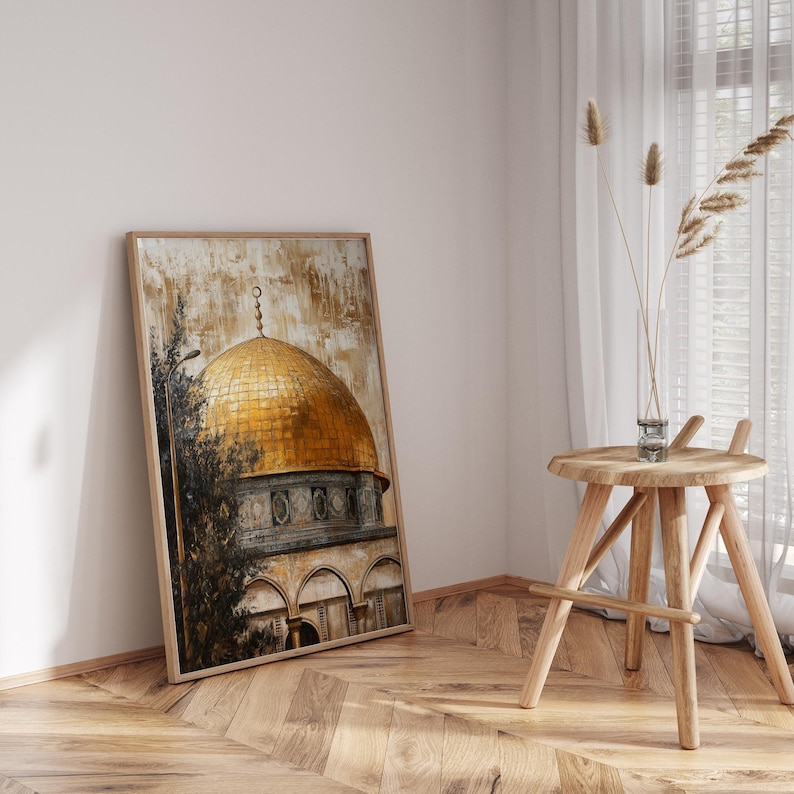 May include: A framed painting of a golden dome building with a brown and green background. The painting is leaning against a white wall.