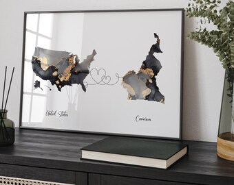 May include: A framed print of a map showing the United States and Cameroon connected by a line with hearts. The map is in black, white, and gold with a watercolor effect. The text "United States" and "Cameroon" is below each map.