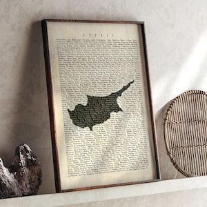May include: Framed map print of Cyprus, featuring the island's silhouette in dark tones against a vintage-style background. The word "CYPRUS" is at the top. The frame is a dark brown color.