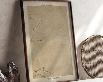 May include: A framed vintage-style map print of Manila, Philippines, in a brown wooden frame. The map features detailed coastlines and is printed on aged paper. The text "Manila, Philippines" is visible at the bottom.