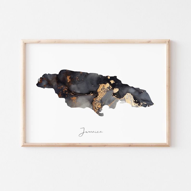 May include: A black and gold abstract art print of the island of Jamaica. The print is framed in a light wood frame and has the word "Jamaica" written in cursive at the bottom.