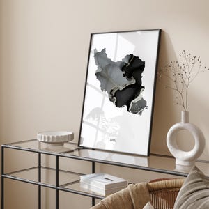 May include: A black and white abstract map of Iran in a black frame on a white background. The map is made of a textured material that looks like marble. The word "IRAN" is printed in black at the bottom of the map.