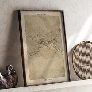 May include: A framed map print of Lienz, Austria, in a brown wooden frame. The map is a sepia tone with the city's layout and coordinates at the top. The text "LIENZ, AUSTRIA" is at the bottom.