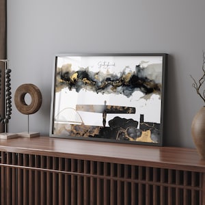 May include: Black and gold abstract art print featuring the Angel of the North sculpture in Gateshead, England. The print has a black frame.