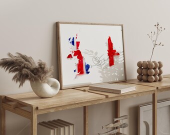 May include: A framed print featuring a watercolor map of the United Kingdom in red, white, and blue. The artwork is displayed on a wooden shelf with decorative items, including a vase with dried flowers and a wooden sphere sculpture.