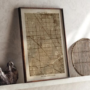 May include: Framed vintage-style map of Oak Park, United States, in shades of brown. The map features detailed street layouts and is encased in a dark brown wooden frame. Coordinates are visible at the top. The text "Oak Park, United States" is at the bottom.