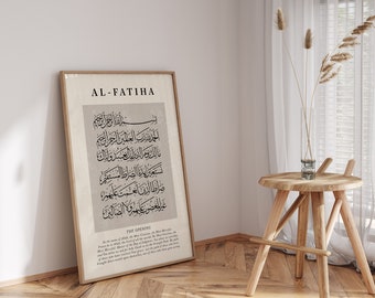 May include: A framed print titled "AL-FATIHA" in black text. The print features Arabic calligraphy in black on a beige background. The text below the calligraphy reads "THE OPENING" and includes a translation of the Arabic text.