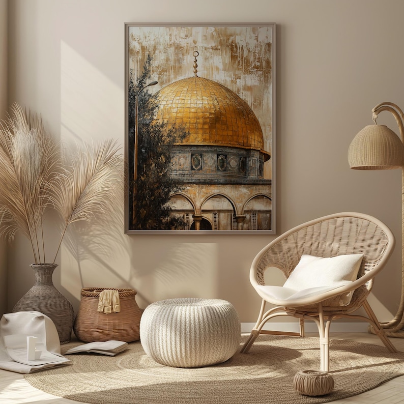 May include: A painting of a golden dome mosque with intricate details, framed and hanging on a wall in a living room setting. A wicker chair with a white cushion sits in front of the painting, along with a woven basket and a white ottoman.