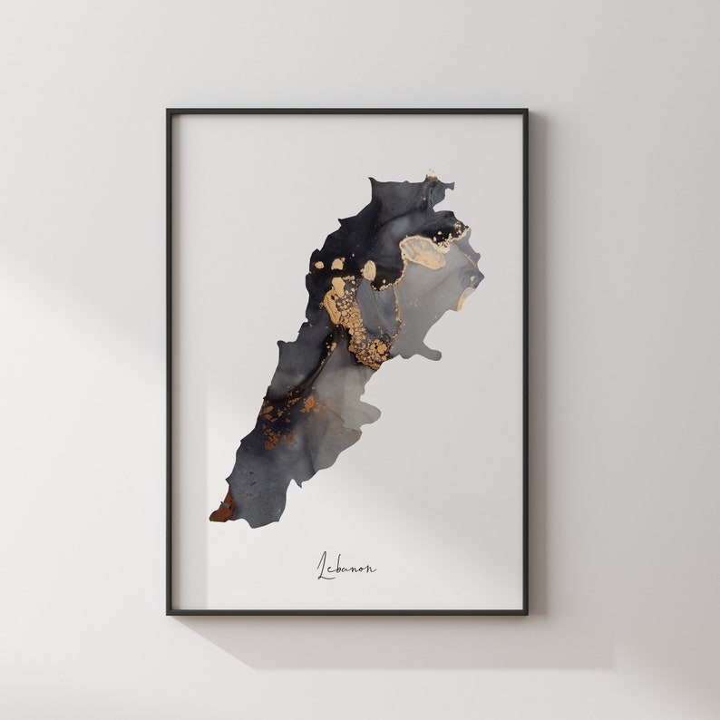 May include: A black and gold abstract art print of the country of Lebanon. The print is framed in a black frame and has the word "Lebanon" written in cursive at the bottom.