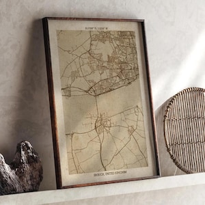 May include: Framed vintage map print of Brough, United Kingdom, in sepia tones. The map features detailed road and building outlines, with the text "Brough, United Kingdom" at the bottom. Coordinates are printed at the top.