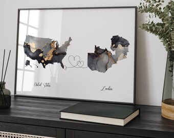 May include: A framed print of a map of the United States and Zambia connected by a line with two hearts. The map is in black, gray, and gold with a watercolor effect. The text "United States" and "Zambia" is printed below the maps.