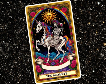 May include: Tarot card illustration featuring a skeleton riding a rainbow unicorn, with a glass of wine in hand. The card is titled "The Audacity" and has a gold frame with roses and a sun.