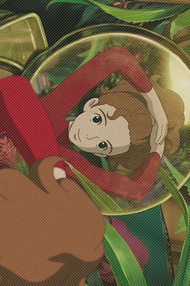 May include: A young girl with brown hair lies on her back in a red shirt, surrounded by green leaves and a large, clear, round object.