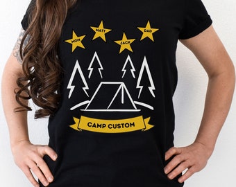 May include: Black t-shirt with a white graphic of a tent, trees, and stars. The stars have names written on them: Mom, Matt, Jack, and Dad. The text below the graphic says "Camp Custom".