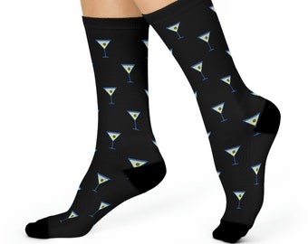 May include: A pair of black socks with a repeating pattern of martini glasses with green olives. The socks are shown on a white background.