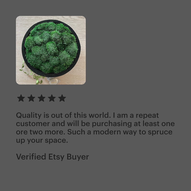 May include: A circular black frame containing a dense arrangement of vibrant green preserved moss. The moss has a textured, clumping appearance and fills the entire interior of the round container, creating a solid, uniform surface of deep green.