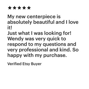 May include: Five star review for a centerpiece. The reviewer states that the centerpiece is absolutely beautiful and they love it. They also mention that the seller, Wendy, was very quick to respond to their questions and was very professional and kind. The review concludes with the reviewer stating that they are very happy with their purchase. The review is labeled as a Verified Etsy Buyer.