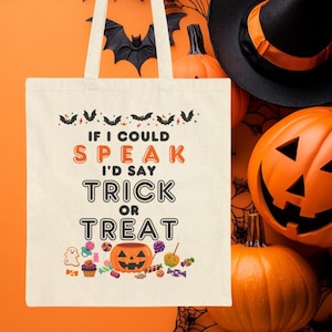 May include: A white canvas tote bag with a Halloween design. The bag features bats, candy, and the text "If I could speak I'd say trick or treat".
