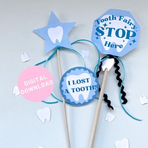May include: Three tooth fairy themed props for a lost tooth party. A blue star with a white tooth, a blue circle with the text "I lost a tooth!" and a blue stop sign with the text "Tooth Fairy Stop Here".