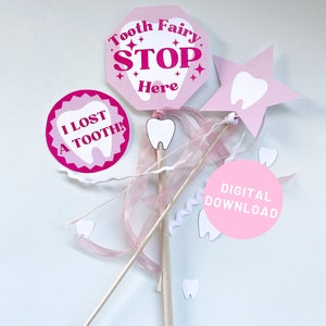 May include: Pink and white tooth fairy party decorations with a sign that says "Tooth Fairy Stop Here", a star with a tooth on it, and a circle that says "I lost a tooth!"