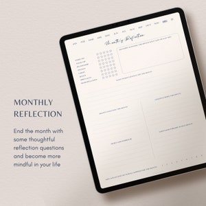 May include: A digital tablet with a monthly reflection planner on the screen. The planner includes sections for rating different aspects of life, identifying challenges, and reflecting on lessons learned. The text "Monthly Reflection" is at the top of the screen.