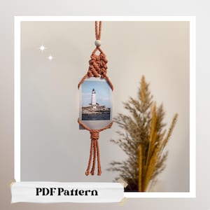 May include: A macrame photo holder in a warm terracotta color, displaying a picture of a lighthouse. The holder is suspended from a knotted cord with a wooden bead. The words "PDF Pattern" are at the bottom.