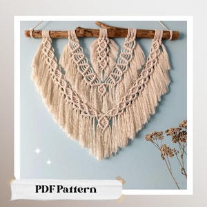May include: A beige macrame wall hanging with a wooden dowel at the top. The macrame is in a triangular shape with a fringe at the bottom. The text "PDF Pattern" is at the bottom of the image.