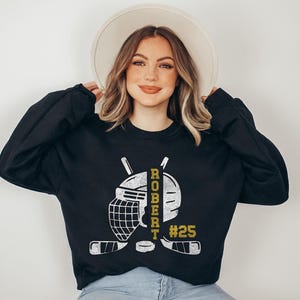 Personalized hockey hoodie with player name, number, and team colors. Perfect gift for players, fans, and teams, available for kids and adults!