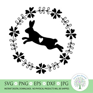 May include: Black silhouette of a bunny rabbit jumping through a wreath of flowers. The bunny has a small heart on its chest.