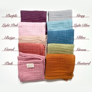 May include: Ten squares of fabric in different colors, including purple, light pink, beige, coral, pink, gray, light blue, blue, green, and mustard. The fabric is a soft, textured muslin.