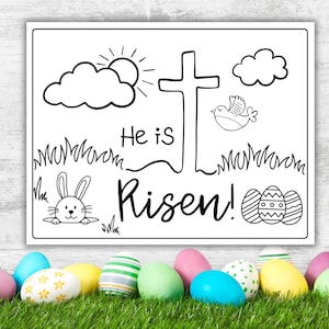 May include: Black and white coloring page with a cross, a bird, clouds, a sun, grass, a bunny, and Easter eggs. The text says "He is Risen!"