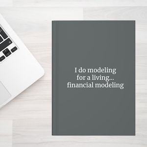 May include: A dark gray notebook with the text "I do modeling for a living... financial modeling" printed in white.