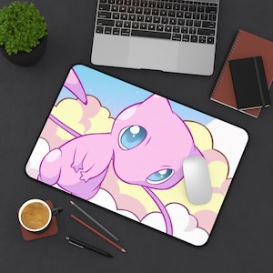 May include: A pink and blue mousepad with a cartoon image of a pink and blue Pokemon character with a long tail. The character is flying in the clouds.