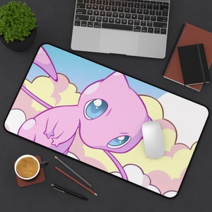 May include: A pink and white mousepad with a cartoon image of a pink, flying, mythical creature with blue eyes. The creature is surrounded by clouds and stars.
