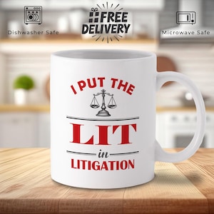May include: White ceramic mug with the text "I PUT THE LIT in LITIGATION" in red, with a scale of justice graphic. The mug is dishwasher and microwave safe.